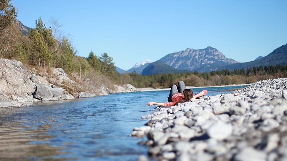 person sitting at river